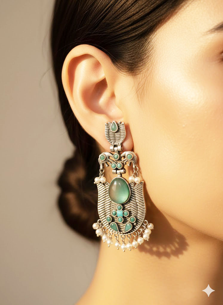 oxidized silver toned minakari drop earrings with green stones and pearl droplets oxidized silver toned minakari drop earrings with green stones and pearl droplets