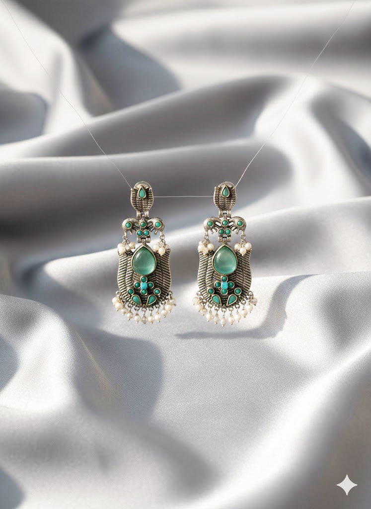 oxidized silver toned minakari drop earrings with green stones and pearl droplets oxidized silver toned minakari drop earrings with green stones and pearl droplets